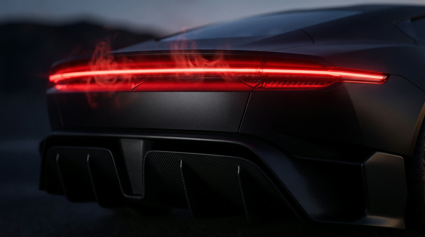 Macro detail of the VASAV full-width rear light blade and carbon diffuser